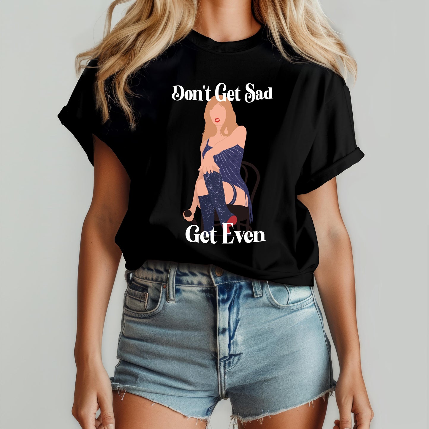 Woman wearing a black t-shirt with a bold illustrated figure and the phrase “Don’t Get Sad, Get Even” – inspired by Taylor Swift’s Midnights album aesthetic