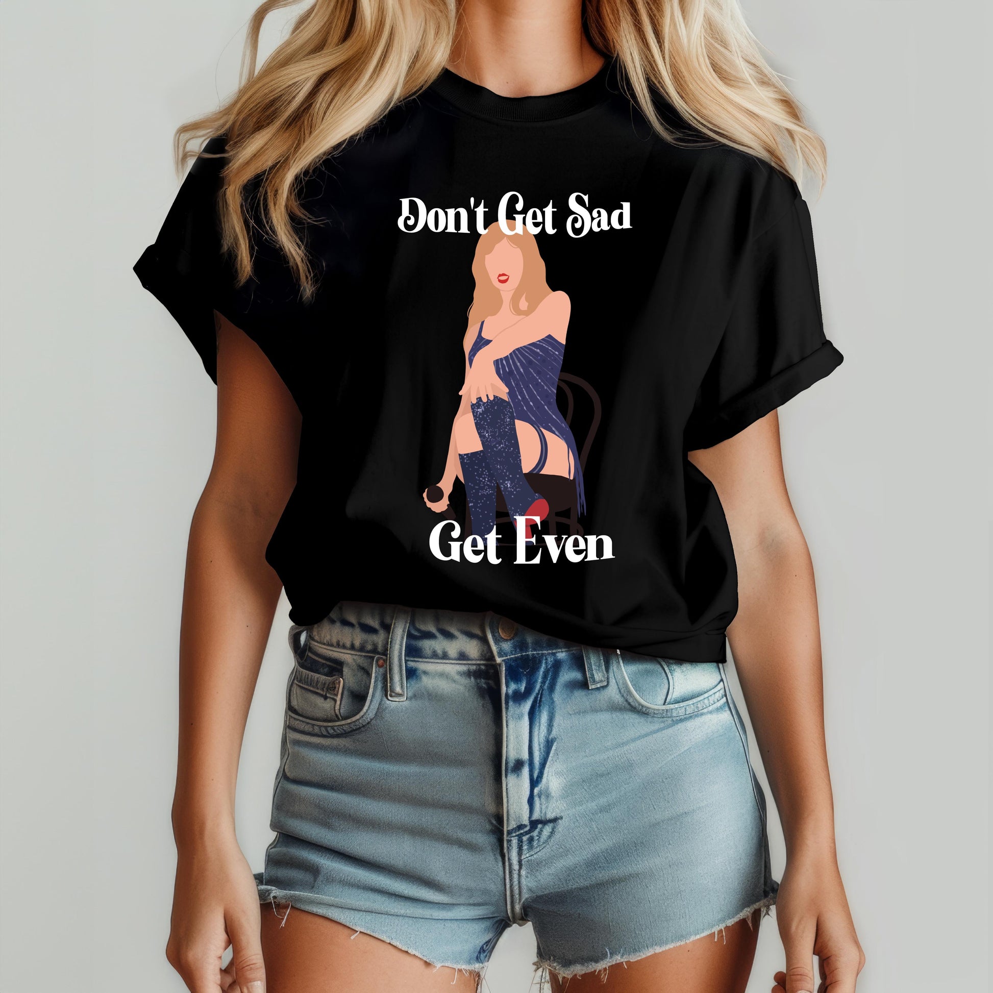 Woman wearing a black t-shirt with a bold illustrated figure and the phrase “Don’t Get Sad, Get Even” – inspired by Taylor Swift’s Midnights album aesthetic