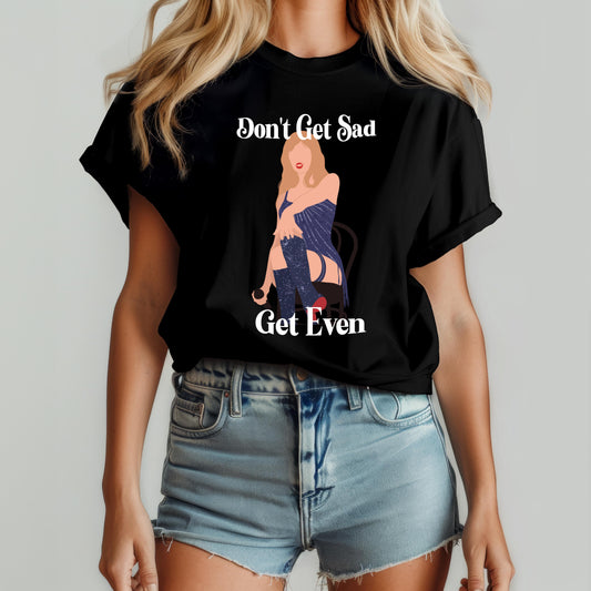 Woman wearing a black t-shirt with a bold illustrated figure and the phrase “Don’t Get Sad, Get Even” – inspired by Taylor Swift’s Midnights album aesthetic