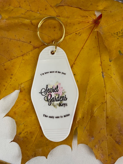 “Secret Gardens” Keychain – I Hate It Here Inspired Motel Tag